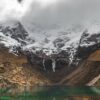 body of water near snow-covered mountain